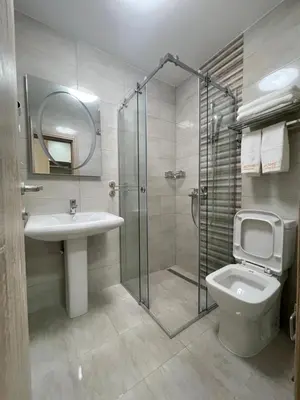 a bathroom with a shower and a sink and a toilet at home in superior如家 in Surčin