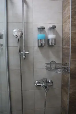 a bathroom with a shower with a glass door at home in superior如家 in Surčin
