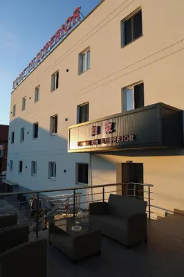 a hotel with a sign on the side of a building at home in superior如家 in Surčin