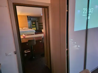 a room with a door leading to a bedroom at Jacuzzi Vaki Apartment in Belgrade