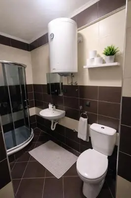 a bathroom with a toilet and a sink at Apartman Quality in Voždovac