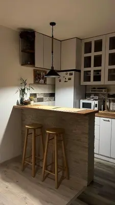a kitchen with two bar stools and a counter top at Sanska 25 in Dušanovac (historical)