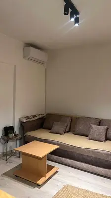 a living room with a couch and a table at Sanska 25 in Dušanovac (historical)