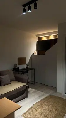 a living room with a couch and a table at Sanska 25 in Dušanovac (historical)