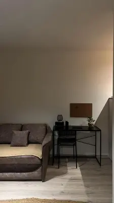 a living room with a couch and a desk at Sanska 25 in Dušanovac (historical)