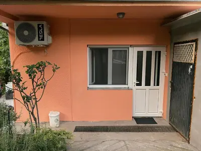 an orange house with a white door and a window at Sanska 25 in Dušanovac (historical)