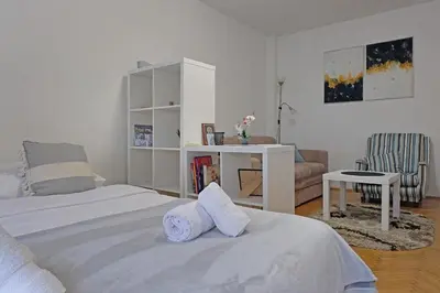 a bedroom with a bed with two towels on it at Vintage Dream Apartment in Belgrade
