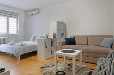 a living room with a couch and a table at Vintage Dream Apartment in Belgrade