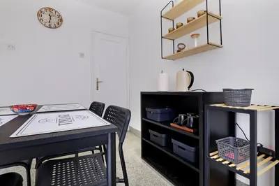 a dining room with a black table and chairs at Vintage Dream Apartment in Belgrade