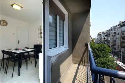 a balcony with a table and a window at Vintage Dream Apartment in Belgrade
