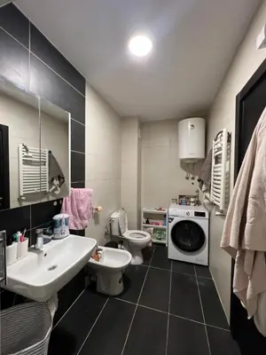 a bathroom with a sink and a washing machine at Lovely flat in Vračar (historical)