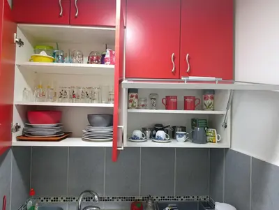 a kitchen with red cabinets and a sink at Sofija 1 in Vračar (historical)