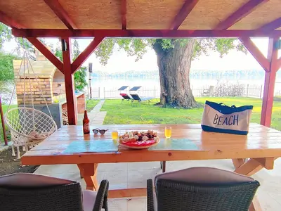 a picnic table with a bowl of fruit on it at Dadula na Dunavu in Kovin