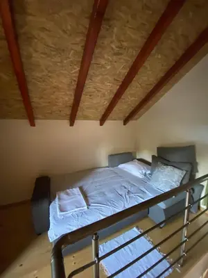 a bed with white sheets and pillows in a room at Dadula na Dunavu in Kovin