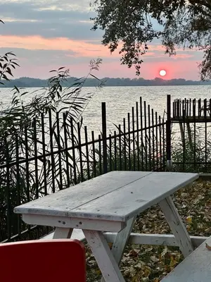 a picnic table in front of a body of water at Dadula na Dunavu in Kovin