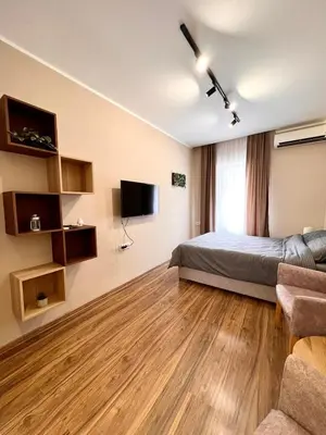 a bedroom with a bed and a flat screen tv at Old Gold Downtown Belgrade in Belgrade