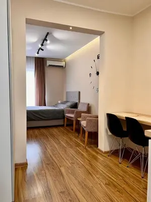 a room with a bed and a table and chairs at Old Gold Downtown Belgrade in Belgrade