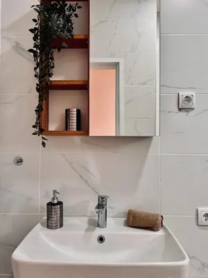 a bathroom with a sink and a mirror at Old Gold Downtown Belgrade in Belgrade