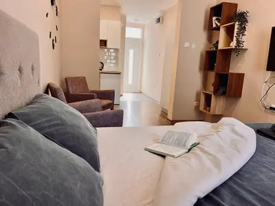 a living room with a couch with a book on it at Old Gold Downtown Belgrade in Belgrade