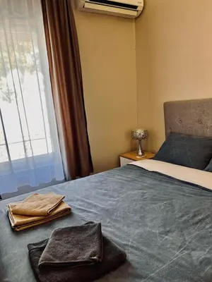 a bedroom with a bed with two towels on it at Old Gold Downtown Belgrade in Belgrade