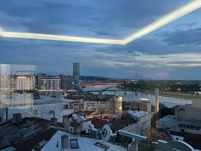 a view of a city at night with at Central Sky View Apartment in Belgrade