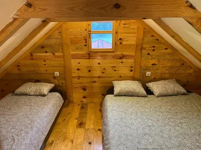 two beds in the attic of a log cabin at Vikendica Milošević in Arandjelovac