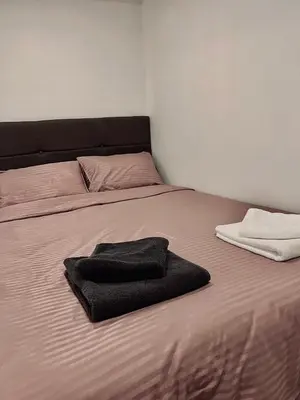 a bed with two towels sitting on top of it at Stone House Central Belgrade Studio in Belgrade