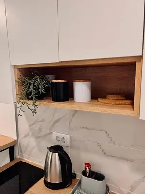 a kitchen with white cabinets and a counter top at Stone House Central Belgrade Studio in Belgrade