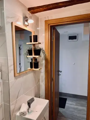 a bathroom with a sink and a mirror at Stone House Central Belgrade Studio in Belgrade
