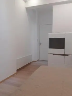 an empty room with white walls and a television at Beograd /Slavija - fontana 70 m2 in Sajmište