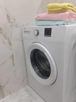 a washing machine with towels on top of it at Beograd /Slavija - fontana 70 m2 in Sajmište
