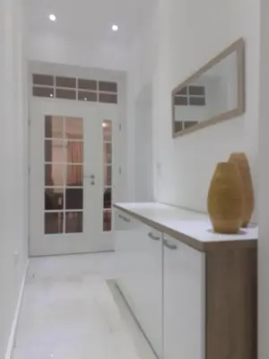 a kitchen with white walls and a counter and a window at Beograd /Slavija - fontana 70 m2 in Sajmište