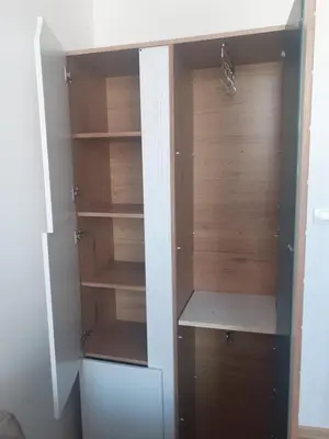 a closet with wooden shelves in a room at Beograd /Slavija - fontana 70 m2 in Sajmište