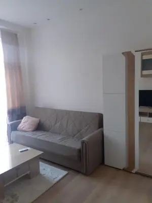 a living room with a couch and a table at Beograd /Slavija - fontana 70 m2 in Sajmište