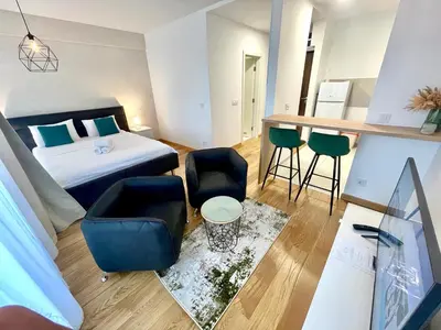 a room with a bed and a table and chairs at Green - stan na dan studio Novi Beograd, parking 5 evra dan in Belgrade