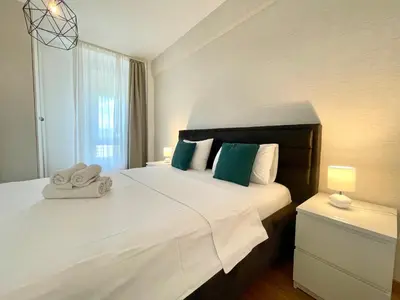a bedroom with a large white bed and a window at Green - stan na dan studio Novi Beograd, parking 5 evra dan in Belgrade