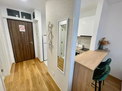 a small apartment with a kitchen and a desk and a door at Green - stan na dan studio Novi Beograd, parking 5 evra dan in Belgrade