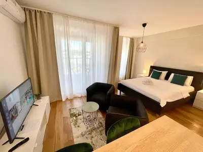 a hotel room with a bed and a television at Green - stan na dan studio Novi Beograd, parking 5 evra dan in Belgrade