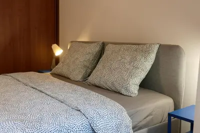 a bed with two pillows on top of it at Comfortable and spacious apartment in one of Belgrade’s most exclusive neighbourhoods in Belgrade
