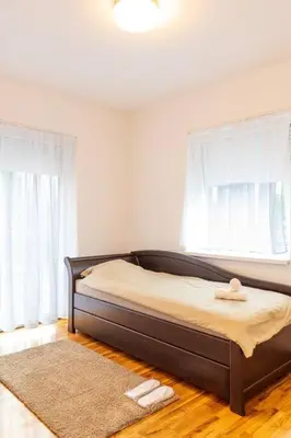 a bedroom with a bed and a window at Royalux Zemun Residences in Belgrade