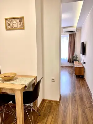 a dining room with a table and chairs at Dani Lux Belgrade Center Studio Apartment in Belgrade