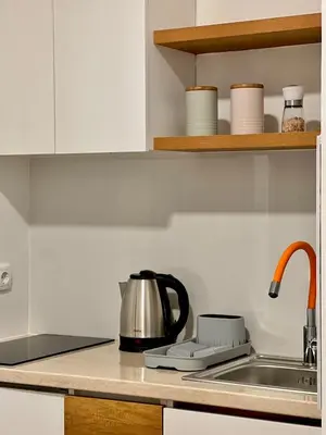 a kitchen counter with a tea kettle and a sink at Dani Lux Belgrade Center Studio Apartment in Belgrade