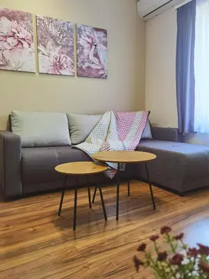 a living room with a couch and two tables at Stefan Suite Belgrade Center Apartment in Belgrade