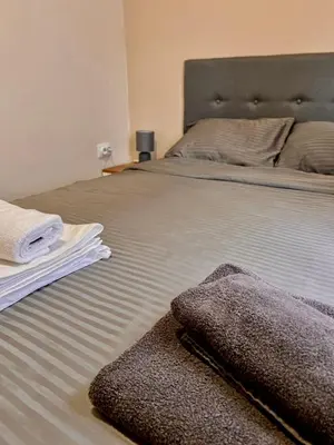 a bedroom with a bed with towels on it at Stefan Suite Belgrade Center Apartment in Belgrade