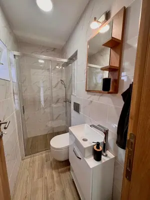 a bathroom with a toilet and a shower and a sink at Stefan Suite Belgrade Center Apartment in Belgrade