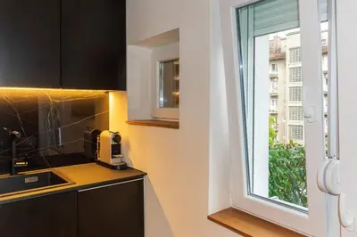 a kitchen with a window next to a sink at Royalux Kennedy Residences in Tošin Bunar