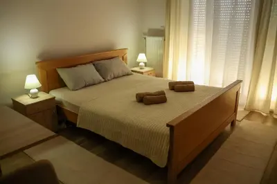 a bedroom with a bed with two teddy bears on it at Apartman San in Ruma