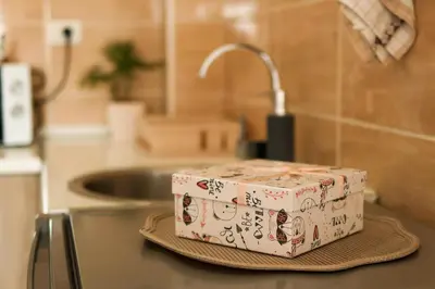 a cake sitting on top of a counter in a kitchen at Apartman San in Ruma