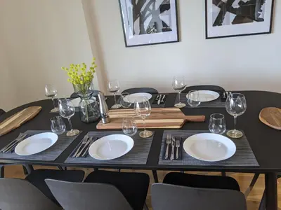 a table with plates and wine glasses on it at Luxury Belgrade Waterfront top floor Apt with an amazing view in Belgrade