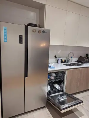 a kitchen with a refrigerator with an open dishwasher at Luxury Belgrade Waterfront top floor Apt with an amazing view in Belgrade